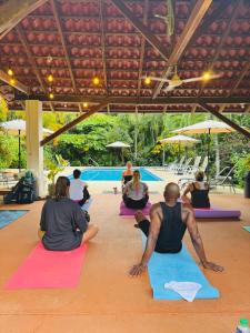 a group of people sitting in a yoga class at Villa Del Sol Boutique Hotel in Coco +105 photos