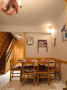 a dining room with a table and chairs at Duplex à la Moutière in Tignes