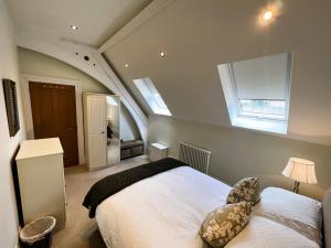 a bedroom with a large white bed and a window at 5 Old School Mews Shanklin in Shanklin