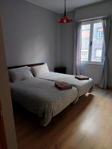 a bedroom with a bed with two pillows on it at Segundo Antolín Yellow Door in Ponferrada