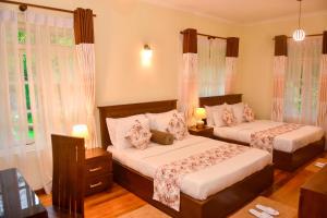 Postel nebo postele na pokoji v ubytování Tea Queens Bungalow
