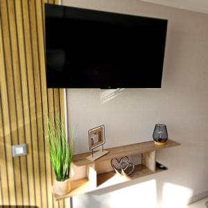 a flat screen tv hanging on a wall at Naturiste Port Nature in Cap d'Agde