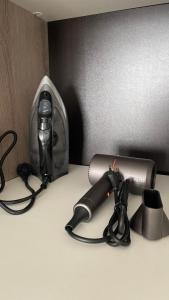 een camera en een haardroger naast een tas bij БЦ Алматы, иманова-валиханова in Astana