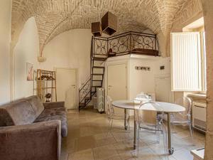 a living room with a couch and a table at Martine Dimore Storiche di Puglia in Martina Franca