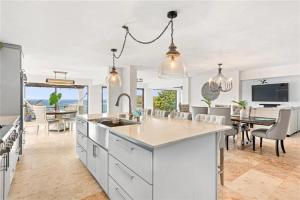 an open kitchen and dining room with a view of the ocean at Just a few minutes walking to the Beach Club in Sabana