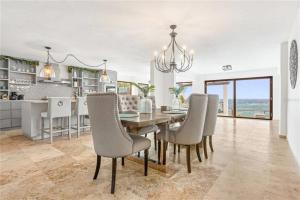 a kitchen and dining room with a table and chairs at Just a few minutes walking to the Beach Club in Sabana