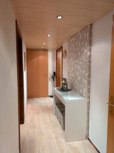 a room with a kitchen with a counter and a hallway at Haus Walch in Pettneu am Arlberg +3 photos