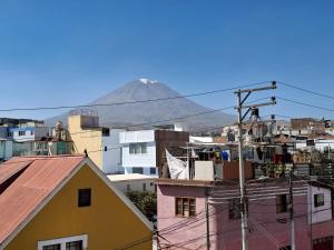 a view of a mountain from a city with buildings at Hotel Sideral AQP in Arequipa