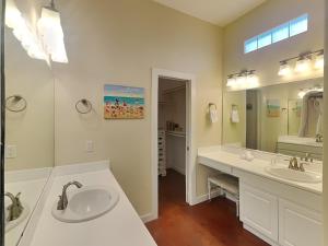 a bathroom with two sinks and a large mirror at Jamaica Me Happy in Port Aransas +14 photos