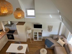 a living room with a couch and a table at Gemütliches Reetdachhaus in Oesterdeichstrich