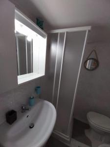 a bathroom with a sink and a toilet and a mirror at Casa dolce casa in Casamassima