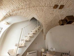 a staircase in a house with a brick ceiling at Martine Dimore Storiche di Puglia in Martina Franca