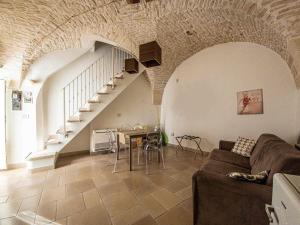a living room with a couch and a staircase at Martine Dimore Storiche di Puglia in Martina Franca