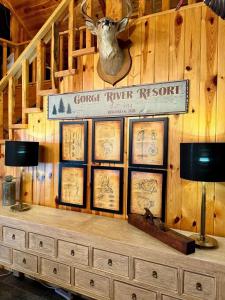 a sign on a wall with a deer head on it at Rustic 5 Bedroom Gorge River Resort in Walhalla