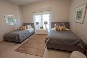 a bedroom with two beds and a window at Just a few minutes walking to the Beach Club in Sabana +23 photos