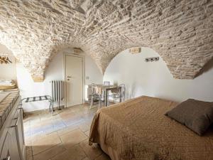 a bedroom with a bed and a table in it at Martine Dimore Storiche di Puglia in Martina Franca