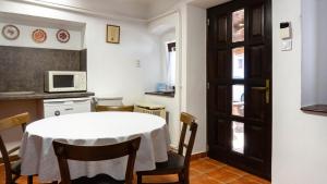 a small kitchen with a table and a microwave at Hajnal Vendégház in Kéked
