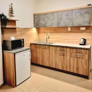a kitchen with a sink and a microwave at Turecka 49 Apt 1 in Nové Zámky