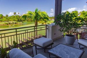 a balcony with chairs and a view of the water at Just a few minutes walking to the Beach Club in Sabana