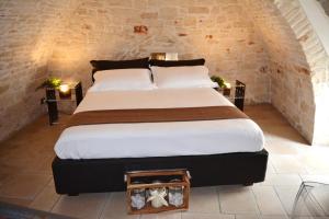 a bedroom with a large bed in an attic at Martine Dimore Storiche di Puglia in Martina Franca