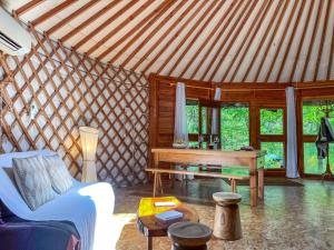 a living room with a table in a yurt at Yourte Cantal in Vitrac +50 photos