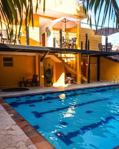 a swimming pool in front of a house at Curazao Hotel -Centro Histórico- in Santa Fe de Antioquia