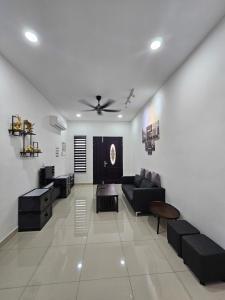 a living room with a couch and a table at V-Home Taiping, 3BR, 7pax, Full Aircond, Wifi & Netflix, Early Bird Promo in Taiping