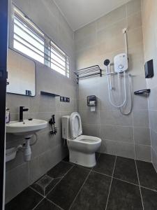 a bathroom with a shower and a toilet and a sink at V-Home Taiping, 3BR, 7pax, Full Aircond, Wifi & Netflix, Early Bird Promo in Taiping +29 photos