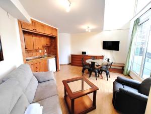 a living room with a couch and a table at SKI & SNOW APARTMENTOS by TODOSIERRANEVADA - Plaza de Andalucia - Junto a los Telecabinas in Sierra Nevada