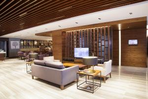 a lobby with couches and chairs and a television at Bof Hotels Business in Istanbul