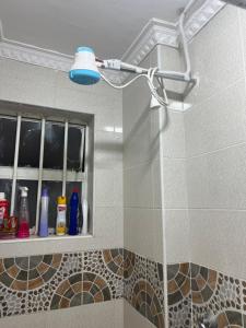 a shower in a bathroom with a blue light at Modern Haven in Nairobi