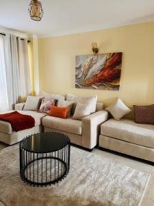 a living room with a couch and a table at Modern Haven in Nairobi