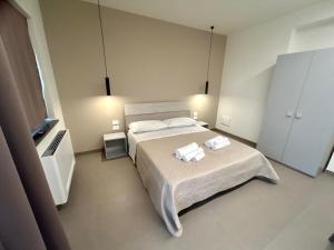 Postel nebo postele na pokoji v ubytování Arkè Rooms