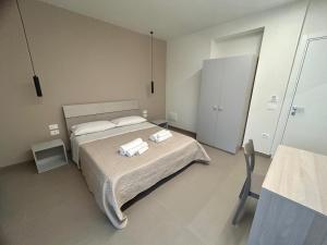 Postel nebo postele na pokoji v ubytování Arkè Rooms