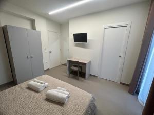 Postel nebo postele na pokoji v ubytování Arkè Rooms