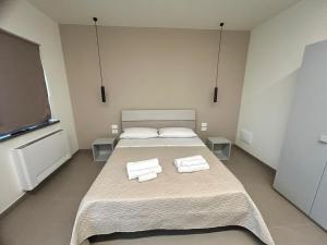 Postel nebo postele na pokoji v ubytování Arkè Rooms
