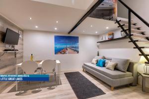 a living room with a couch and a table at Little Americas Museum Apartments in Budapest