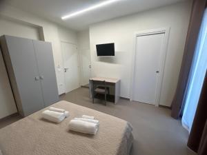 Postel nebo postele na pokoji v ubytování Arkè Rooms