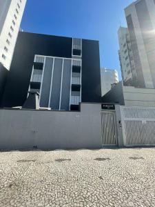 a building in a city with tall buildings at Dona Regina in Matinhos