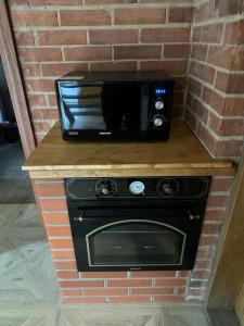 a microwave sitting on top of a brick wall at D&R Apartments in Mažeikiai +13 photos
