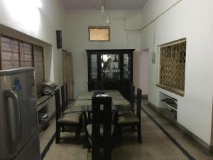 a dining room with a table and chairs in a room at Sangam Homestay in Prayagraj +11 photos