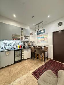 a kitchen with a table and a dining room at Charles V Marais Apartment in Paris +26 photos