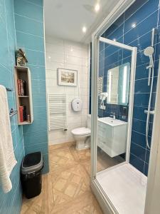 a bathroom with a shower and a toilet and a sink at Charles V Marais Apartment in Paris