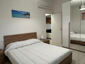 a bedroom with a large bed and a mirror at Sire Home in Aranova
