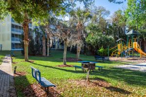 a park with two benches and a playground at Barefoot'n Resort Kissimmee Orlando in Orlando