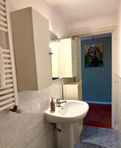 a bathroom with a white sink and a mirror at La casa di Sophie in Bagno a Ripoli +10 photos