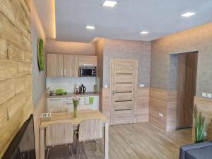 a kitchen and dining room with a table and chairs at Apartment Jasna - Lucky in Demanovska Dolina