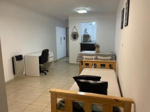 een kamer met 2 bedden en een bureau bij Departamento Vista Bella, céntrico y cercano a la terminal, Exc ubicación, playa estacionamiento cercana-económica in Villa María +19 foto's