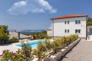 a villa with a swimming pool and a house at Villa Opera in Povile