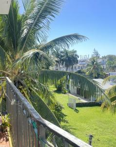 a view from a balcony of a yard with palm trees at Seahorse Appartments in Grand Baie